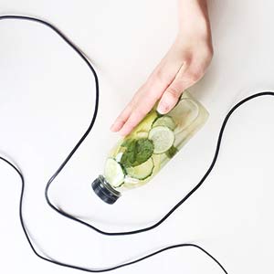 Photo of a bottle full of mint, cucumber, and other herbs. Click on the photo for more information about Homemade toner. 